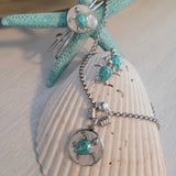 Stainless steel set of necklace, bracelet, and earrings, with sea turtle charm.
