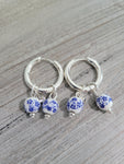 Silver color hoop earrings with white and blue flower beads