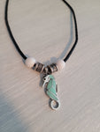 Black cord necklace with aqua and silver color seahorse charm.