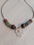 Single cord necklace with wood beads, silver plated octopus charm, and real seashell charm