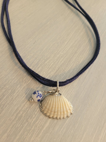 Double suede cord necklace with sea shell charm.