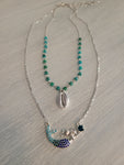 Layered silver color necklace with aqua green beads, shell charm, and mermaid