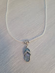 Shimmering white single cord necklace with beach sandal charm