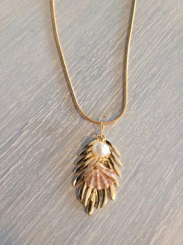 Gold color necklace with leaf, pearl and natural seashell charms