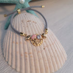 Adjustable cord bracelet with seashells charm